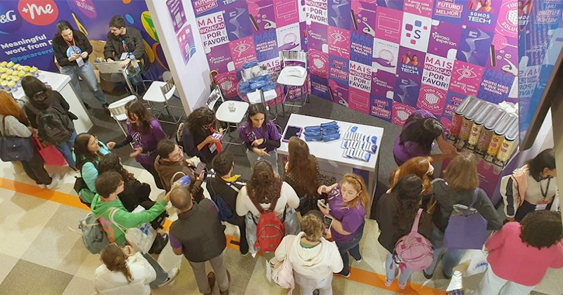 Grupo de alunos reunidos em estande de um evento de intercâmbio no campus da USP em São Paulo